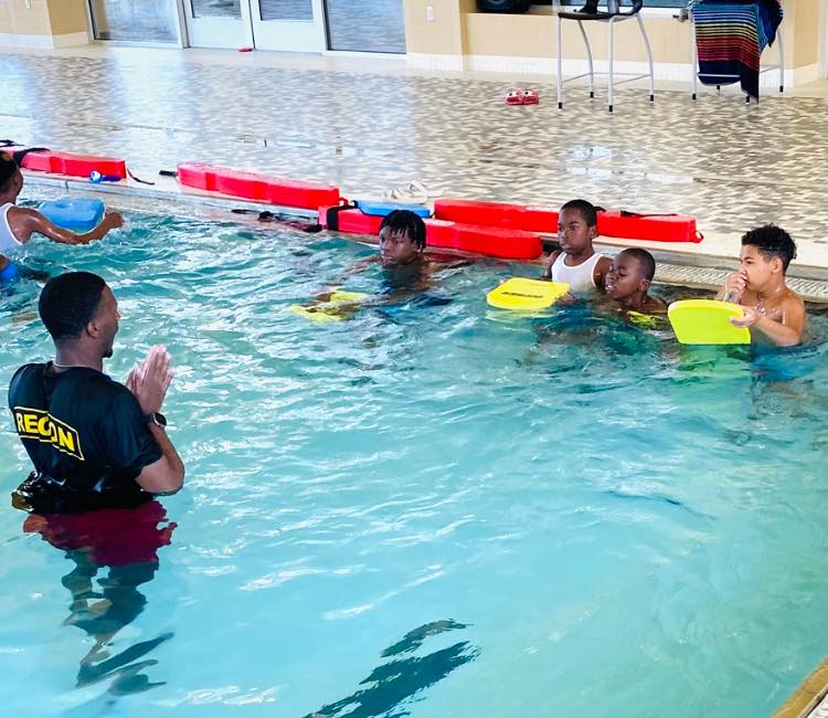 Five boys in a pool.